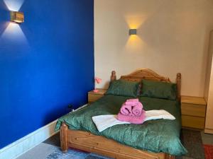 a bedroom with a bed with a towel on it at The Tartan Sheep in Kilmarnock
