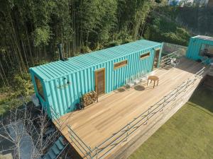 a blue house sitting on top of a wooden deck at THE W Relax Garden Resort - Vacation STAY 09071v in Yoshioka