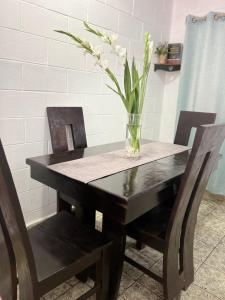 a table with a vase with flowers on it at Cowboys Home in Juayúa +10 photos