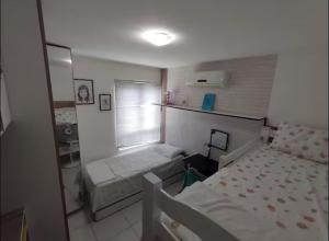 a small bedroom with two beds and a window at Casa Lagos do Frances in Marechal Deodoro +5 photos