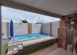 a jacuzzi tub on the balcony of a house at Casa Lagos do Frances in Marechal Deodoro