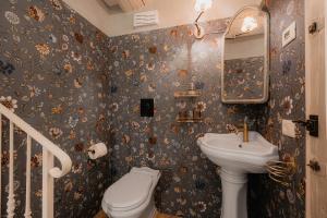 a bathroom with a sink and a toilet at Dimora Lucia - Camere Relax con bagno privato in Fossombrone