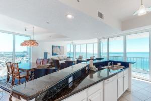 a kitchen and dining room with a view of the ocean at Palazzo 1401 in Panama City Beach