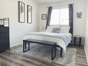 a bedroom with a large bed and a window at Lovely Home Central Coalinga in Coalinga