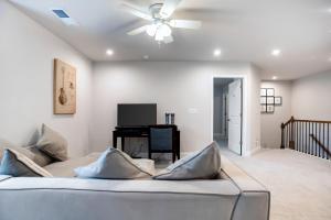 a living room with a couch and a ceiling fan at New Charming Surburban Retreat 12 mins to Lakepoint in Acworth