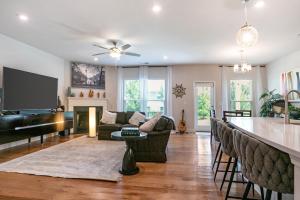 a living room with a bar and a piano at New Charming Surburban Retreat 12 mins to Lakepoint in Acworth