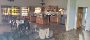 a kitchen and living room with a couch and a table at Hillcrest Haven in Kingstown