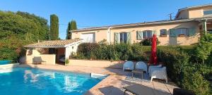 a house with a swimming pool in front of a house at La Casa Del Sol - Chambres de Charme avec piscine chez l'habitant in Léojac