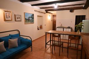 a living room with a blue couch and a table at il Cantuccio in Pitigliano
