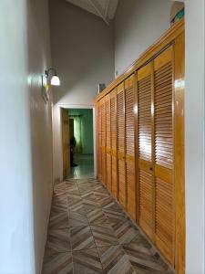 a hallway with wooden lockers in a room at Hillcrest Haven in Kingstown