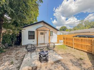 a backyard with two chairs and a house at 1 BR Fire Pit BBQ Retreat in Evansville