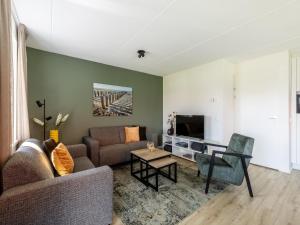Una sala de estar con un sofá y un televisor. en Holiday Home in Scherpenisse near Oosterschelde, en Scherpenisse
