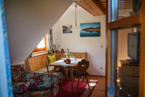 a living room with a table and a tv at Bio-Bauernhof Anawander in Mariahof
