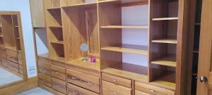 a wooden closet with wooden shelves and cabinets at Hillcrest Haven in Kingstown