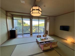 a living room with a table and a large window at Peace Inn Hagi - Vacation STAY 92109v in Hagi