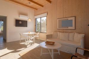 a living room with a couch and a table at Anastasio Hotel & Beach Club in José Ignacio