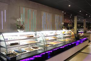 a display case filled with different types of pastries at Hotel De Hertog in Franeker
