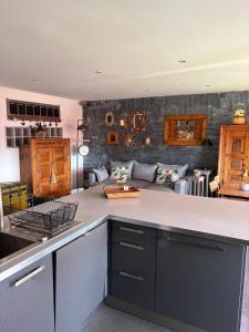 a kitchen with a counter top and a living room at Superbe appartement avec piscine et parking in Fréjus
