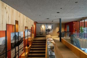 a staircase leading up to a room with glass walls at La Tambra - Hotel Lodge in Santa Cristina in Val Gardena