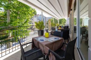 a patio with a table and chairs on a balcony at Hotel Bridge in Rimini