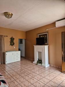 a living room with a fireplace and a tv at Casa Gracia in Jamay