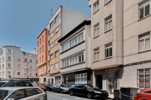 a row of cars parked in front of buildings at San vicente in A Coruña