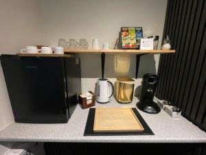a kitchen counter with a counter top with a refrigerator at Amma Jóna rooms in Ásólfsskáli