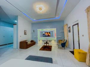 a living room with a couch and a tv at Serene Haven in Mama