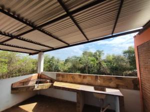 a porch with a bench and a large window at Departamento 1er Piso-Costa del Potiy in Encarnación