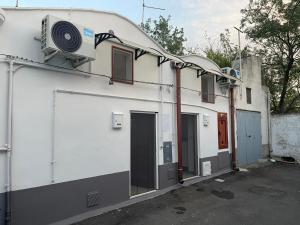 a white building with a fan on the side of it at MINI HOUSE in Montescaglioso +4 photos
