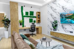 a living room with a couch and a desk at Апарт-отель Urban Luxe Mirabad 8 in Toshkent-Passajir Bekati