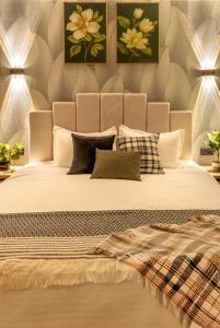 a bedroom with a large bed with four pillows at Апарт-отель Urban Luxe Mirabad 8 in Toshkent-Passajir Bekati