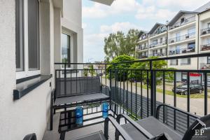 a balcony with a view of a street at Apartament BEATA 102 Dziwnówek 200m od plaży EPapartamenty in Dziwnówek