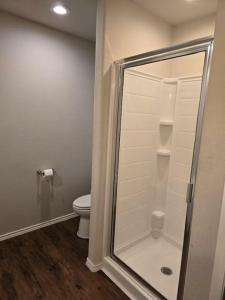 a bathroom with a shower and a toilet at Katy's five bedrooms home away from home! in Katy
