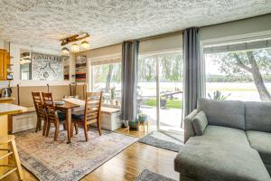 a kitchen and living room with a table and a couch at Riverfront Duplex Dock and Views in Nine Mile Falls in Nine Mile Falls