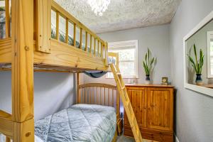 a bedroom with a bunk bed and a ladder at Riverfront Duplex Dock and Views in Nine Mile Falls in Nine Mile Falls