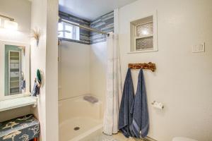 a bathroom with a shower and a shower curtain at Riverfront Duplex Dock and Views in Nine Mile Falls in Nine Mile Falls +20 photos
