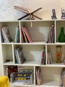 a white book shelf filled with books at Diamond Residence Fes in Fez +5 photos