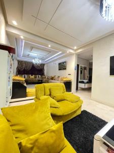 a living room with yellow couches at Diamond Residence Fes in Fez