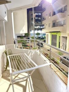 a white chair on the balcony of a building at Diamond Residence Fes in Fez