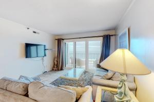 a living room with a couch and a tv at Plaza 505 in Ocean City