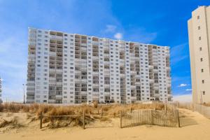 a large apartment building on the beach with the sand at Plaza 505 in Ocean City