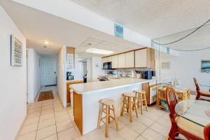 a kitchen with a bar and a table and chairs at Plaza 909 in Ocean City