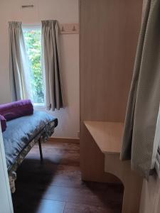 a room with a bench and a window at Hendre Glamping- Caravan Bryngwyn in Boncath