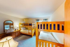 a bedroom with two bunk beds and a mirror at Mountainside Resort H203 in Stowe +82 photos