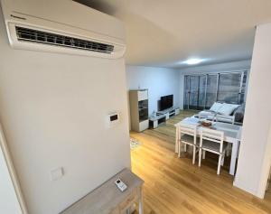 a living room with a table and a couch at Lagoa Nest in Lagoa