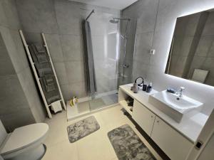 a bathroom with a sink and a shower and a toilet at Lagoa Nest in Lagoa +10 photos