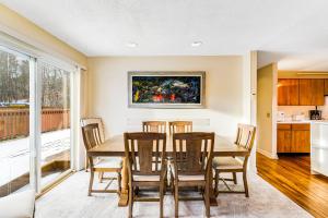 a kitchen and dining room with a table and chairs at Mountainside Resort F303 in Stowe
