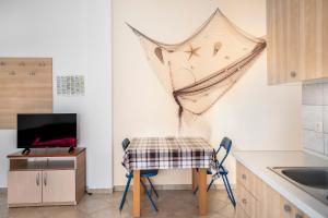 a kitchen with a table and chairs and a sink at Apartment Draga in Vir