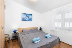 a bedroom with a bed with blue pillows on it at Apartment Draga in Vir +51 photos